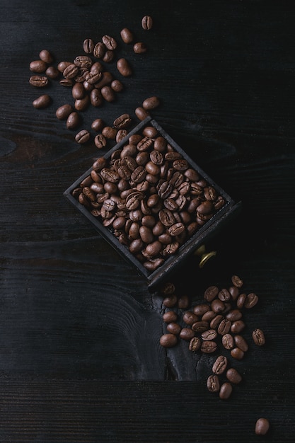 Grains de café torréfiés sur fond noir