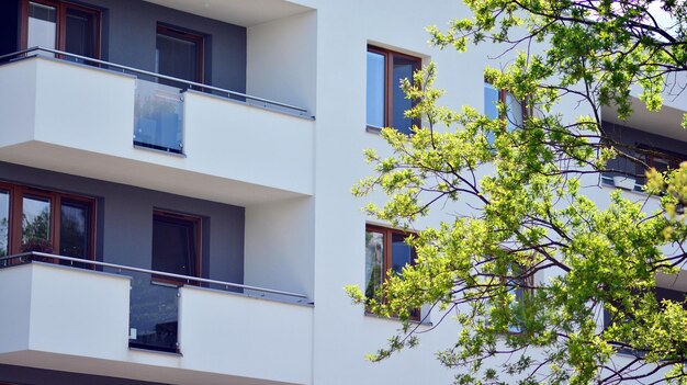 Photo un grand bâtiment blanc avec des balcons sur le côté