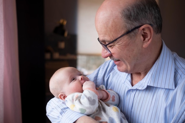 Grand-père tenant une belle petite fille nouveau-née