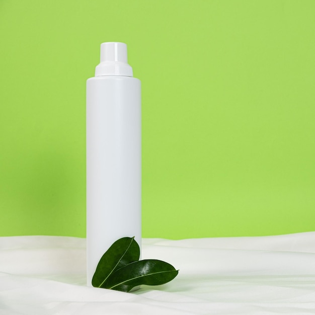 Grande bouteille en plastique blanche pour les produits chimiques ménagers sur fond vert Espace pour le texte