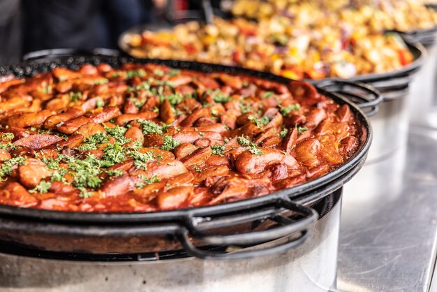 Photo une grande casserole chaude pleine de nourriture de réconfort hivernale sous forme de suasage et de ragoût de pâte de tomate