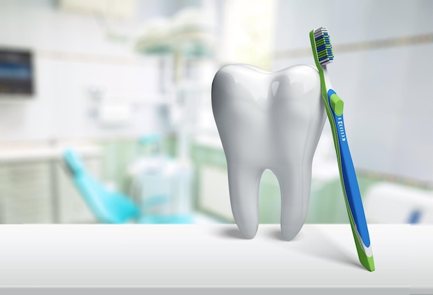 Grande dent et miroir de dentiste dans la clinique de dentiste sur l'arrière-plan