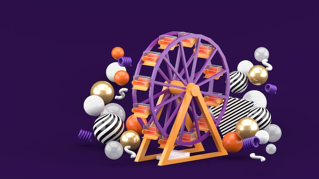 Grande roue parmi les boules colorées sur un espace violet