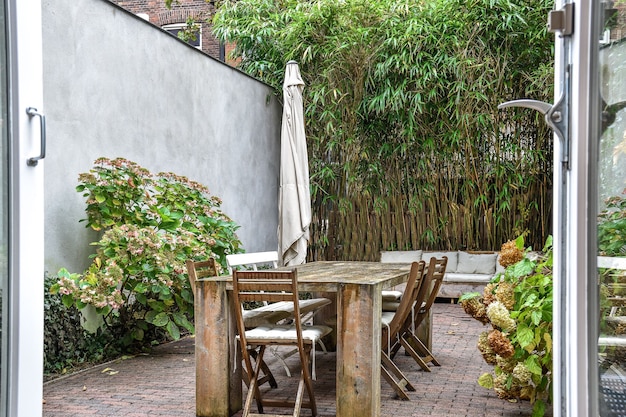 Grande table et chaises en bois dans la cour