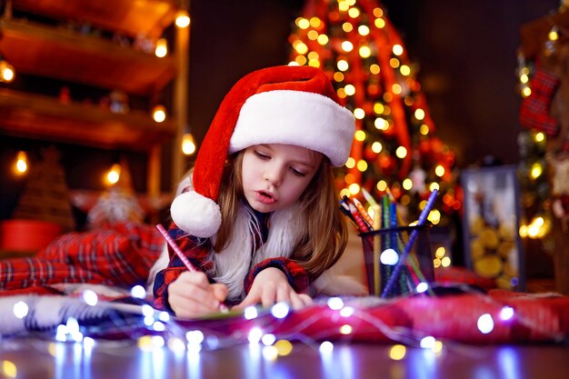 Grandhomme en bonnet de Noel écrit une lettre au père Noël