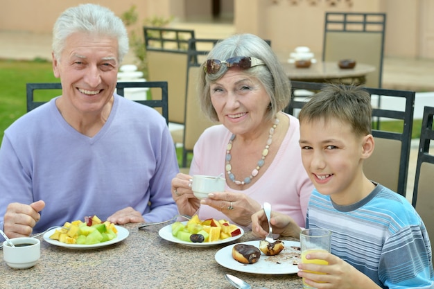 Grands-parents avec petit-enfant au petit-déjeuner sur tropical resort