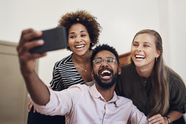 De grands sourires de la part de la meilleure équipe créative Photo d'un groupe d'hommes d'affaires prenant des selfies ensemble dans un bureau