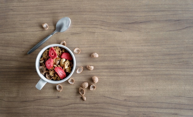 Granola maison au lait pour le petit déjeuner sur la table en bois. vue de dessus