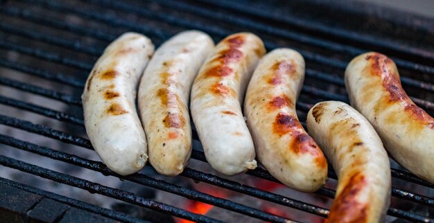 Griller des saucisses sur un barbecue. Mise au point sélective.