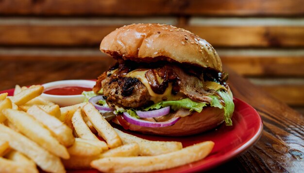 Gros cheeseburger et chips sur une plaque.