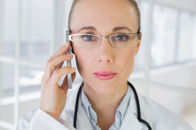 Gros plan d&#39;une belle femme médecin à l&#39;aide de téléphone portable