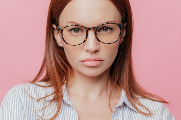 Gros plan de la belle modèle féminin porte de grosses lunettes optiques