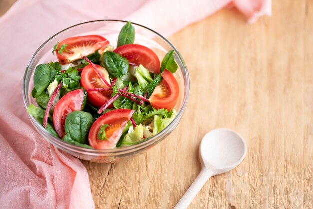 Gros plan d'un bol de salade d'été sur la table. Copiez l'espace, nature morte, mise au point sélective.