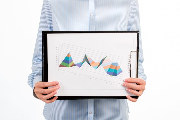 Gros plan sur les chartes graphiques de la femme. Femme d'affaires montrant le presse-papiers avec des diagrammes. Que de chemin parcouru. Certainement mieux que l'an dernier.