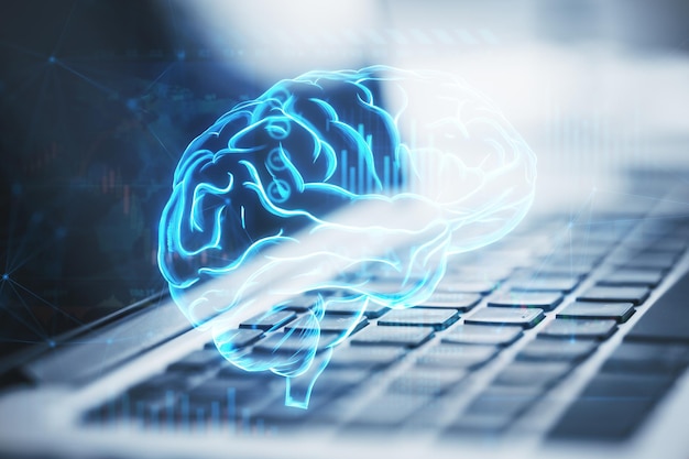Gros plan sur un clavier d'ordinateur portable avec un hologramme de cerveau numérique brillant sur un arrière-plan flou Le concept d'intelligence cerveau travail processus de pensée Double exposition
