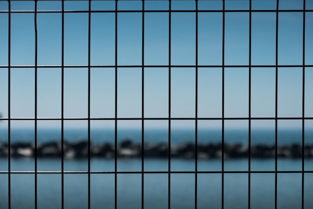 Photo un gros plan d'une clôture métallique contre le ciel bleu