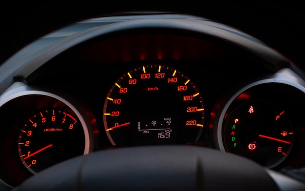 Gros plan du compteur de vitesse de voiture avec l'aiguille pointant sur 0 kmp sur fond noir noir