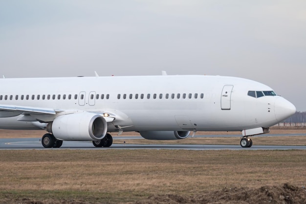 Gros plan du roulage d'un avion de ligne blanc à l'aéroport