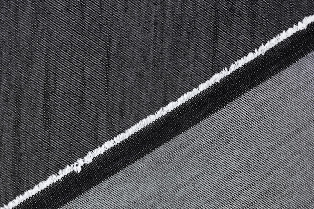 Gros plan du tissu de jeans noir et gris fond texturé matériel abstrait pour les vêtements