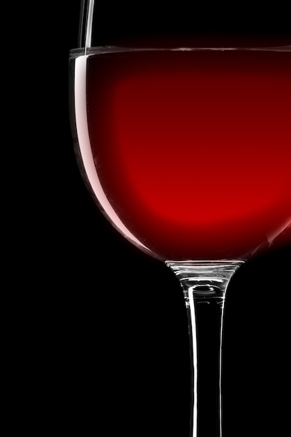 Gros plan du verre à vin de vin rouge isolé sur noir