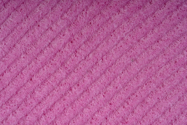 Gros plan d'éponges de nettoyage ménager Texture de détail d'éponge Texture d'éponge gros plan Texture d'éponge rouge de cellulose Treillis métallique rose sur fond de surface d'éponge