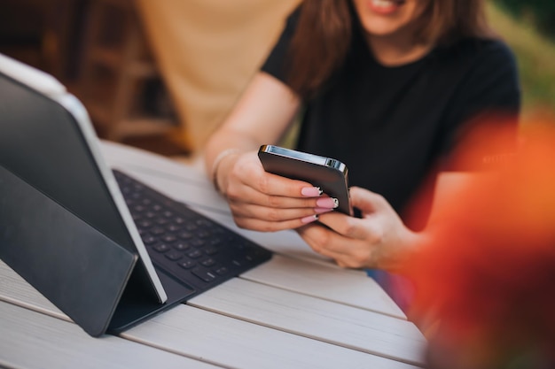 Gros plan d'une femme indépendante parlant au téléphone et utilisant un ordinateur portable sur une tente de glamping confortable par une journée ensoleillée Tente de camping de luxe pour les vacances d'été en plein air et les vacances Concept de style de vie