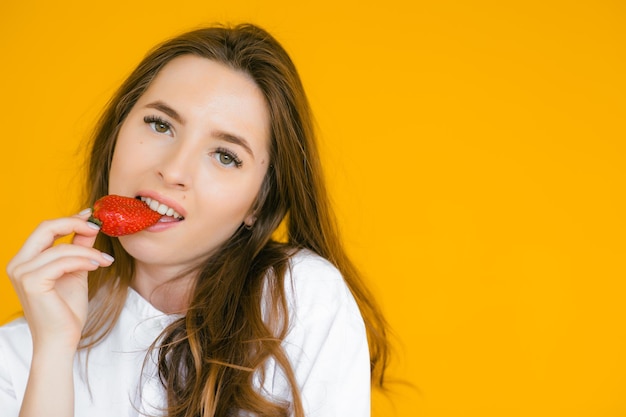 Gros plan d'une femme sexy mangeant des fraises fraîches Lèvres sexuelles Rouge à lèvres Concept d'aliments sains