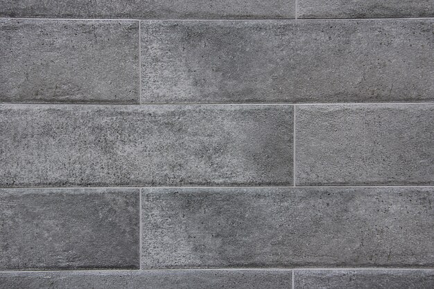 Gros plan de fond de texture de mur de bloc de marbre gris.