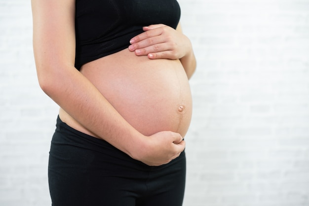 Gros plan d&#39;un joli ventre de femme enceinte