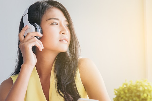 gros plan de jolie femme se détendre avec de la musique dans la tristesse d&#39;humeur par les écouteurs