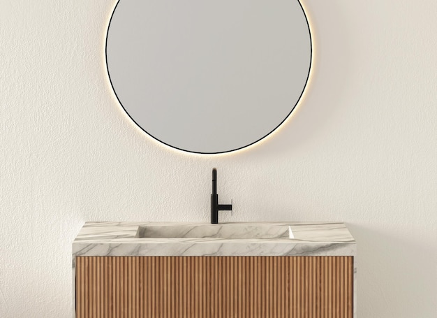 Gros plan sur un lavabo en marbre blanc sans accessoires et robinet noir. Le miroir ovale est accroché au mur.