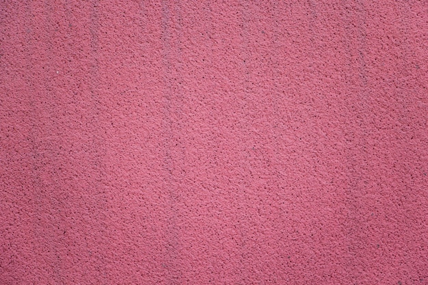 Gros plan de mur en stuc rose vif