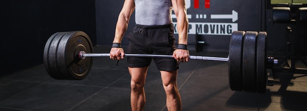 Gros plan sur les muscles abdominaux du bodybuilder Entraînement d'homme musclé dans la salle de sport Taille de la bannière