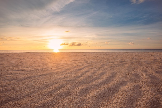 Gros plan sur la plage de sable de la mer Paysage de plage au coucher du soleil Orange doré rayons de soleil sable paysage marin côte tropicale