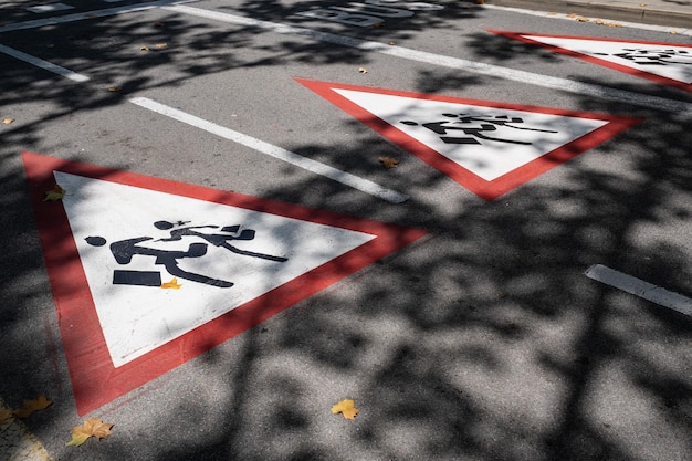 Gros plan sur la route avec panneau de passage à niveau scolaire indiquant que les enfants traversent la rue