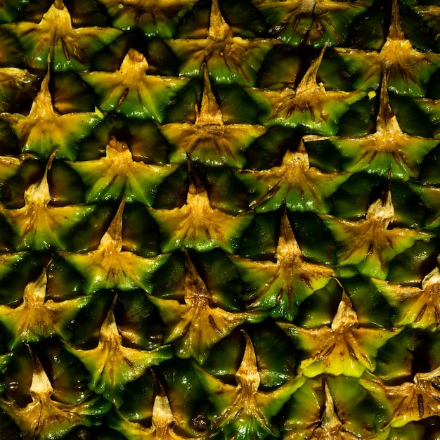 Photo gros plan de la texture de peau d'ananas écorce d'ananas motif de fond d'ananas texture de peau d'ananas