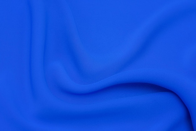 Gros plan texture de tissu bleu naturel ou de tissu de même couleur Texture de tissu de soie de coton naturel ou de laine ou de lin textile fond de toile bleue