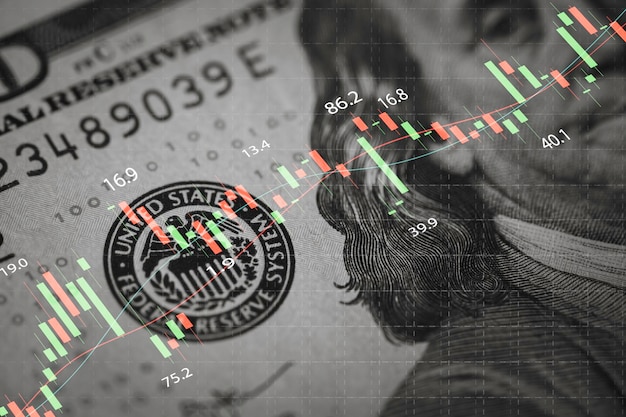 Gros plan sur le visage de Benjamin Franklin sur un billet en USD avec un graphique boursier pour l'échange de devises et le concept de commerce mondial forex