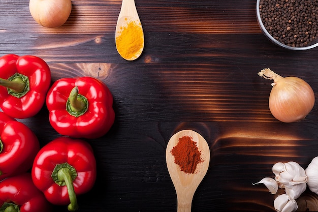 Gros plan Vue de dessus sur les légumes frais et les épices en poudre sur une planche de bois brûlée