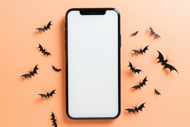 Gros téléphone maquette écran blanc sur fond de citrouilles d'Halloween heureux