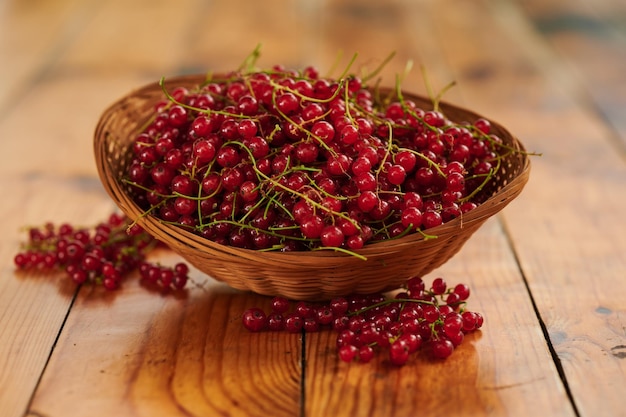 Groseilles rouges fraîchement baies dans un panier sur la table