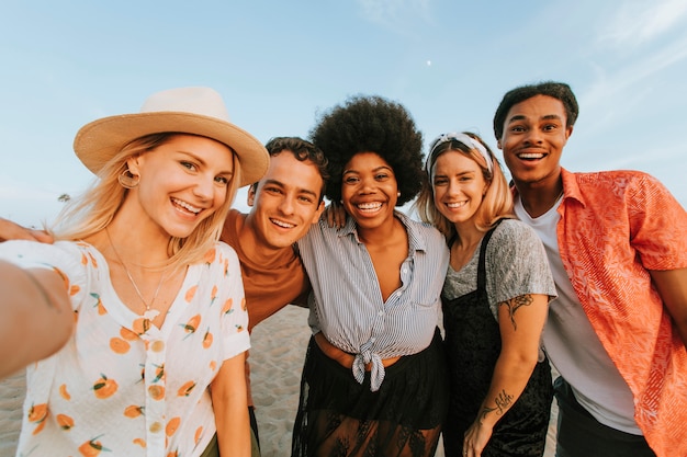 Groupe d&#39;amis divers prenant un selfie à la plage