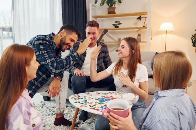 Un groupe d'amis fait une fête à l'intérieur.