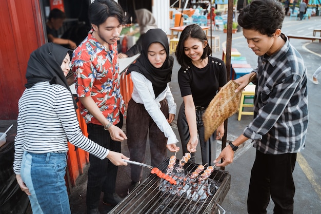 Groupe d'amis grillades avec une brochette