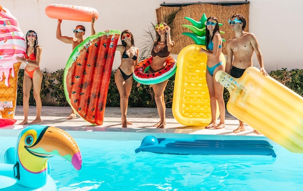 Un groupe d'amis joue ensemble dans la piscine