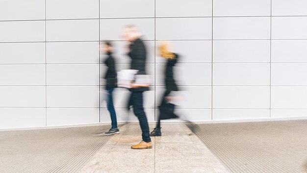 groupe anonyme de personnes se précipitant dans un étage d'un centre d'affaires. idéal pour les mises en page de sites Web et de magazines