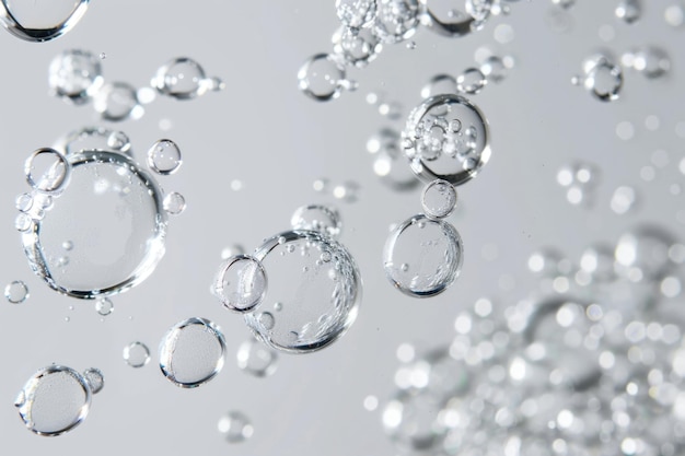 Un groupe de bulles claires s'élève sur un fond blanc