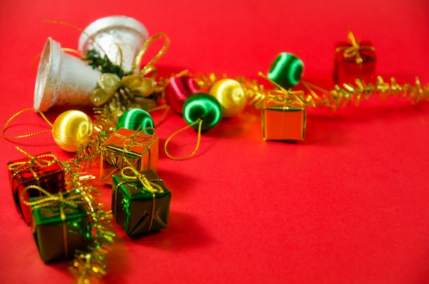 Groupe de cloche, boule et cadeau à Noël sur fond rouge en vue de dessus