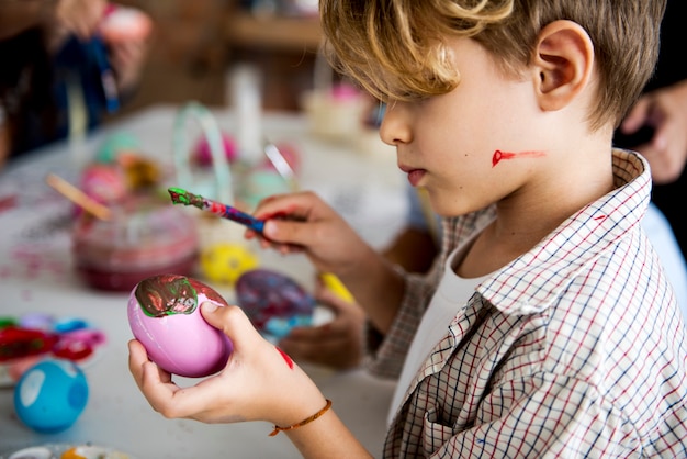 Un groupe d&#39;écoliers de primaire coloriant des oeufs de Pâques