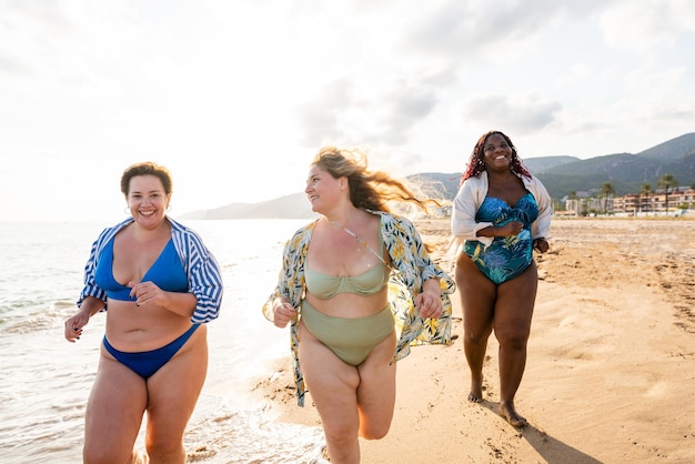 Groupe de femmes de taille plus avec des maillots de bain à la plage